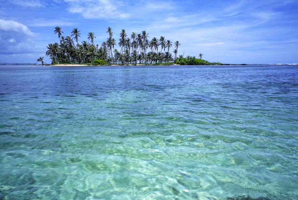 Small private island surrounded by clear water